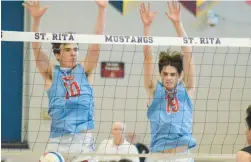  ?? JEFF VORVA/ DAILY SOUTHTOWN ?? St. Rita’s Ryne Jacobsen, right, and Mark Erdmann combine on a block against Hancock in the St. Rita Regional championsh­ip match on Thursday.