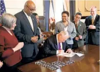  ?? NANCY STONE/CHICAGO TRIBUNE ?? Gov. Pat Quinn signs into law a bill ending the death penalty in Illinois on March 9, 2011, at the State Capitol.