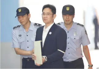  ??  ?? THIS FILE photo taken on Aug. 25 shows Samsung Group heir Lee Jae-yong (C) arriving at Seoul Central District Court in Seoul.