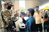  ?? —ANI ?? Marshals stop people who are not wearing masks and challan them at City Market area in Bengaluru on Monday.