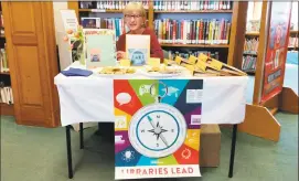  ??  ?? Library Board of Directors member Linda Peech works the baked-goods table derived from recipes of the cookbook on sale, “Sharon Cooks!” the Library's 2017 community cookbook.