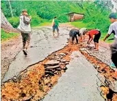  ?? — PTI ?? A damaged road following heavy rainfall in Dima Hasao district of Assam on Tuesday.