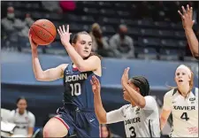  ?? GARY LANDERS/AP PHOTO ?? UConn guard Nika Muhl (10) looks to pass over Xavier guard Aaliyah Dunham (3) during the first half of a game on Feb. 20 in Cincinnati.