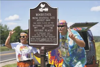  ?? Angela Weiss / AFP / Getty Images ?? Maria Alger of Brazil and Bob Alger of the U.S. arrive at the Bethel Woods Center for the Arts, the original site of the Woodstock Festival, on its 50th anniversar­y in Woodstock, N.Y.