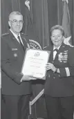  ?? U. S. STRATEGIC COMMAND, STEVE CUNNINGHAM ?? Air Force General John E. Hyten presents Maj. Gen. Heidi Brown with a certificat­e of retirement Friday at Offutt Air Force Base in Nebraska.