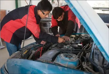  ?? RECORDER PHOTOS BY CHIEKO HARA ?? Vincente Lemus, 15, left, and Tino Garza, 16, check spark plug wires while working on a Pontiac Wednesday, Sept. 12, inside Lindsay High School’s Auto Shop. Students in the Automotive Systems and Repair pathway get real-world experience by working on the vehicles of district employees.