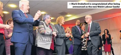  ??  ?? &gt; Mark Drakeford is congratula­ted after being announced as the new Welsh Labour leader