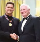  ?? The Canadian Press ?? Gov.-Gen.l David Johnston presents Michael Buble with the National Arts Centre Award during the Governor General’s Performing Arts Awards ceremony at Rideau Hall in Ottawa, June 28.