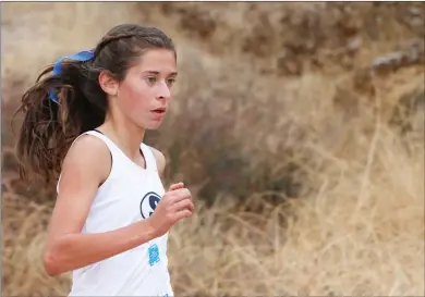  ?? Nikolas Samuels/ The Signal ?? Mariah Castillo of Saugus races in the Foothill League cross country finals where she finished first by more than 30 seconds in the girls varsity race at Central Park in Saugus on Thursday.