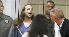  ?? Beth Nakamura/The Oregonian via AP, Pool ?? Jeremy Christian shouts as he is arraigned Tuesday in Portland, Ore. Authoritie­s say he verbally abused two young women, including one wearing a hijab, and when three men intervened, he attacked them, killing two and wounding one.
