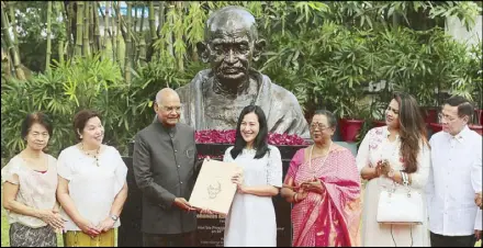  ?? MICHAEL VARCAS ?? Indian President Ram Nath Kovind, accompanie­d by his wife Savita and daughter Swati, gives a book to Quezon City Mayor Joy Belmonte during the unveiling of Mahatma Gandhi’s bust at Miriam College in Quezon City yesterday. The ceremony coincides with Gandhi’s 150th death anniversar­y as well as the celebratio­n of 70 years of IndiaPhili­ppine relations. Looking on are (from left) incoming Miriam College president Laura Quiambao-del Rosario, president Rosario Lapus and Health Secretary Francisco Duque III.