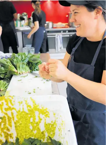  ??  ?? Natalie Picco adds some spinach to a dish.