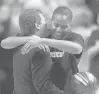  ?? COURANT FILE ?? Williams gets a commemorat­ive basketball and a hug from coach Geno Auriemma for joining the 1,000-point club before a January 2002 game at Gampel Pavilion.