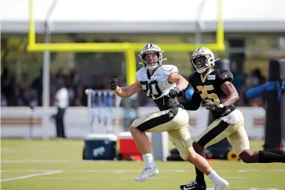  ?? AP Photo/Gerald Herbert ?? ■ New Orleans Saints wide receiver Austin Carr (80) and cornerback Eli Apple (25) run a drill at training camp Monday in Metairie, La.