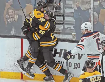  ?? STAFF PHOTO BY MATT STONE ?? HOLD ON TIGHT: Jake DeBrusk (left) jumps into the arms of Joakim Nordstrom after Nordstrom scored during the first period of the Bruins’ win over Edmonton on Thursday night at the Garden.