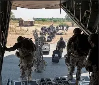  ?? AP/U.S. Air Force/TECH. SGT. MICAH THEURICH ?? Soldiers of the East Africa Response Force file off a U.S. C-130 in Juba, South Sudan, on Wednesday in this photo released Saturday by the Air Force. The soldiers were part of a team deployed to help evacuate civilians.