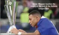  ?? ?? Kylian Mbappe touches the trophy at the end of the Nations League final.