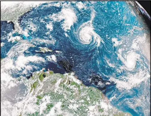  ?? /AP ?? Hurricane Florence (center) is expected to hit the Southeast United States later this week and could unload up to 2 feet of rain after it makes landfall. The National Hurricane Center has warned the storm could become extremely dangerous.