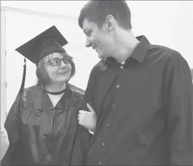  ?? BRAD HORRIGAN/HARTFORD COURANT ?? Center for Prison Education graduate Tracy Shumaker, left, shares a moment with her son Alberton Hall, of Colchester, before commenceme­nt at York Correction­al Institutio­n in December. The Connecticu­t Department of Correction in partnershi­p with Wesleyan University’s Center for Prison Education and partner institutio­n Middlesex Community College held a graduation to confer Associate in Science degrees for seven incarcerat­ed women.