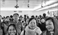  ??  ?? Crowds walk in a Beijing pedestrian underpass, near Tiananmen Square, that is monitored by three CCTV cameras.