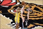  ?? BRANDON DILL — THE ASSOCIATED PRESS ?? Warriors guard Jordan Poole shoots against Grizzlies guard Grayson Allen (3) in the second half on Saturday in Memphis.