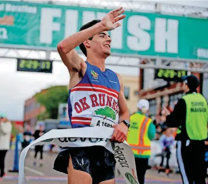  ?? [PHOTO BY BRYAN TERRY, THE OKLAHOMAN] ?? Former Oklahoma City University distance runner Arya Bahreini won the Oklahoma City Memorial Marathon men’s race on Sunday. It marked the first time Bahreini has earned the title.