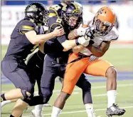  ?? ARKANSAS DEMOCRAT-GAZETTE/ RICK MCFARLAND ?? Nashville’s Darius Hopkins drags Prairie Grove’s Zeke Laird (4) and Isaac Disney (2) with him on a run in the state 4A championsh­ip game at War Memorial Stadium Saturday night.