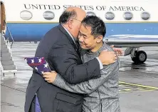  ?? U.S. State Department / AFP / Getty Images ?? U.S. Ambassador Edward McMullen Jr. welcomes Xiyue Wang upon his arrival in Switzerlan­d. Wang had been imprisoned in Iran for more than three years.