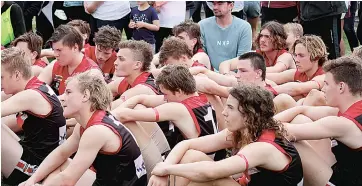  ??  ?? Despite a gallant effort, the Warragul fourths’ side contemplat­e what might have been as they watch Traralgon receive their premiershi­p medallions after falling to the Maroons by 34 points in the grand final last year.