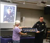  ?? ?? Chico Police Chief Matt Madden presents former police chief Jim Massie's daughter Sherry Massie with the medals her father lost in the Camp Fire. Jim Massey now lives in Yuma Arizona and took part in the ceremony virtually.