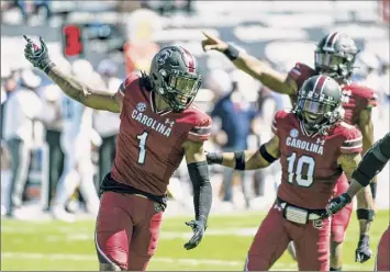  ?? Sean Rayford / Associated Press ?? South Carolina’s Jaycee Horn (1) celebrates an intercepti­on against Auburn during the first half on Saturday. He had two of three Gamecocks picks, which they turned into three TDS.