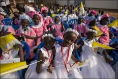  ?? ?? Young girls await the arrival of Pope Francis at the St. Theresa Cathedral in Juba, South Sudan, on Saturday.