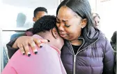  ?? MIKE DE SISTI/MILWAUKEE JOURNAL-SENTINEL ?? Bernice Parks, left, is consoled by Jasmine Wells, the godmother to Sandra Parks, on Tuesday in Milwaukee. Sandra Parks, 13, was killed Monday in her bedroom.