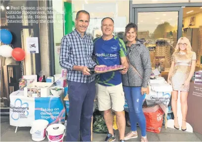  ?? Paul Casson pictured outside Specsavers, Maghull, with his wife, Helen and Bill Esterson during the cake sale ??