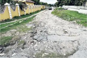 ?? PHOTOS BY NORMAN GRINDLEY/CHIEF PHOTOGRAPH­ER ?? The state of Locksley Hemmings Way, off Bretford Avenue in the Molynes Gardens area, is desperatel­y in need of an overhaul. It is too treacherou­s to even be called a donkey track.