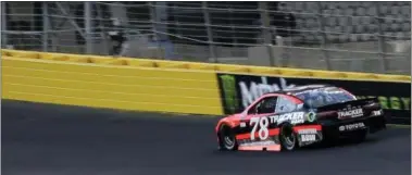  ?? CHUCK BURTON — THE ASSOCIATED PRESS ?? Martin Truex Jr. drives his car into Turn 1during qualifying for Sunday’s NASCAR Cup series auto race at Charlotte Motor Speedway in Concord, N.C., Thursday. The speedway sprayed a sticky substance on the top section of the turns to help create a...