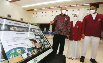  ?? ROBERTUS RISKY/JAWA POS ?? PENGUKUHAN MABA: Rektor Universita­s Muhammadiy­ah Surabaya Sukadiono bersama mahasiswa baru melihat isi surat digital untuk presiden di Gedung At-Tauhid.