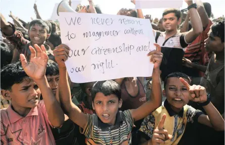  ?? | Reuters ?? A BOY holds a placard as hundreds of Rohingya refugees protest against their repatriati­on at the Unchiprang camp in Teknaf, Bangladesh, yesterday.