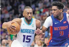  ?? DUANE BURLESON/ASSOCIATED PRESS ?? Kemba Walker (15), shown in action for Charlotte against Langston Galloway and Detroit in April, reportedly is ready to sign with the Boston Celtics.