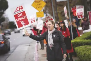  ?? MARCIO JOSE SANCHEZ/AP pickets ?? MICHELE BARTLETT, A PROFESSOR IN THE SOCIAL WORK DEPARTMENT, outside the Cal State Northridge campus on Sunday in Northridge, Calif.