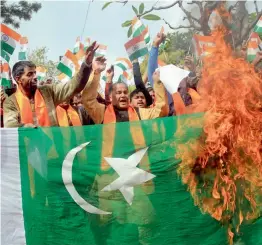  ?? — PTI ?? Shiv Sena activists burn a Pakistani flag during a protest in Jammu on Sunday against the terrorist attack on Sunjwan Army camp.