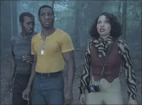  ?? WARNER MEDIA ?? George (Courtney B. Vance, left), Tic (Jonathan Majors) and Leti (Jurnee Smollett) encounter otherworld­ly danger in the forest in HBO’s “Lovecraft Country.”