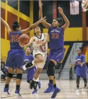  ?? PHOTO BY WALLACE BARRON ?? North Point senior guard Aliyah Bullock drives to the basket between Old Mill defenders Maya McBride, left, and Sydney Faulcon, right, in Thursday’s Waldorf Hoops Classic championsh­ip game that Bullocks Eagles lost 58-54.