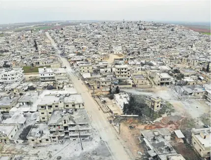  ?? Omar Haj Kadour, AFP/Getty Images ?? An aerial view shows the M5 highway running through Maaret al-Naasan, in Syria’s Idlib province, and the damage done during a weeks-long offensive by regime forces in the country’s last major rebel bastion.