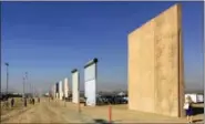  ?? ELLIOTT SPAGAT — THE ASSOCIATED PRESS FILE ?? This file photo shows prototypes of border walls in San Diego. The Trump administra­tion has proposed spending $18 billion over 10 years to significan­tly extend the border wall with Mexico. The plan provides one of the most detailed blueprints of how...