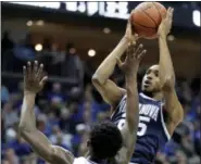  ?? JULIO CORTEZ — THE ASSOCIATED PRESS ?? Villanova guard Mikal Bridges (25) shoots against Seton Hall guard Myles Cale (22) during a game last season.