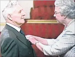  ?? ?? Receiving his MBE from the Queen in 2004