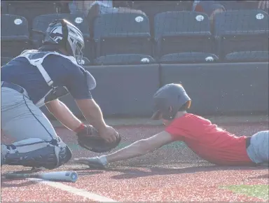  ?? RICK PECK/SPECIAL TO MCDONALD COUNTY PRESS ?? McDonald County’s Jackson Behm gets tagged out at home during the McDonald County 18U baseball team’s 5-2 loss to Joplin on June 3 in an 8-on-8 league in Joplin.