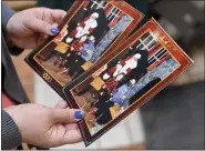  ?? BEN HASTY — MEDIANEWS GROUP ?? Amanda Mosqueda, of Exeter Township holds the photos of her children Vince, 5, and Ella, 1, with Santa at the Berkshire Mall in Wyomissing on Thursday, where Santa began visiting with children for Christmas photos Thursday morning December 3, 2020.