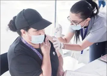  ?? Scott Mullin / For Hearst Connecticu­t Media file photo ?? Cecilia Meza, of Danbury, receives a COVID-19 vaccinatio­n from Fernanda Araujo, a nurse with the Ridgefield Visiting Nurse Associatio­n, at CTown Supermarke­t in Danbury in June.